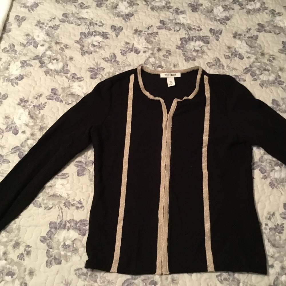 Black zip up fitted sweater with gold toggle zipper and metallic gold trim
